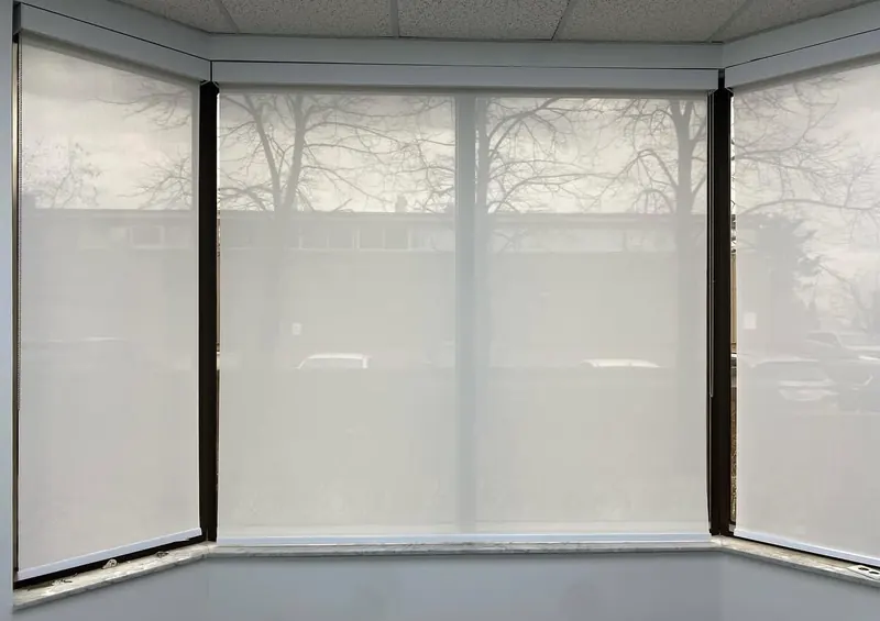 Sheer roller shades across a three-sided bay