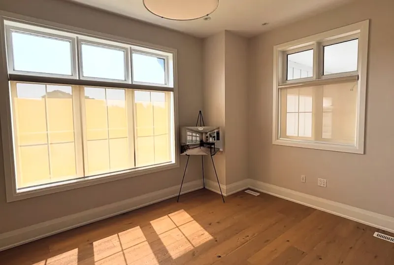 Sheer roller shades in a sunny, empty room