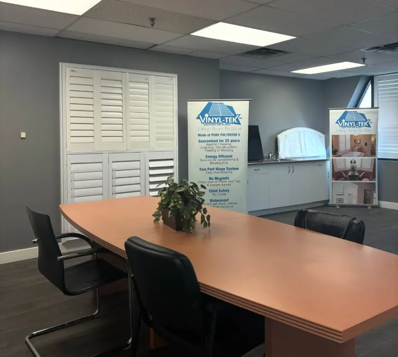 The Ontario Blinds showroom, with sample shutters behind a meeting table
