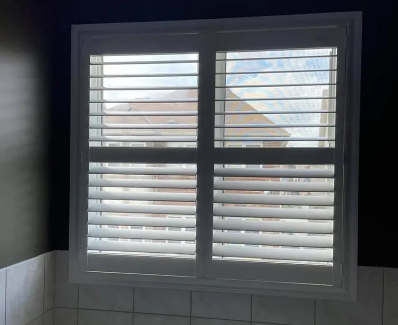 White shutters against a dark accent wall
