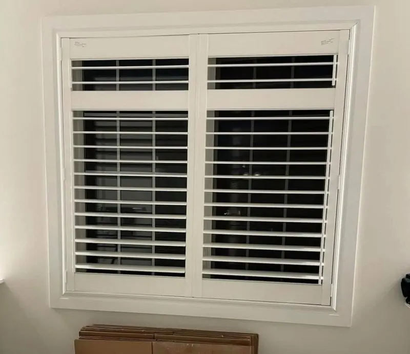 Shutters with divider rails on a double window