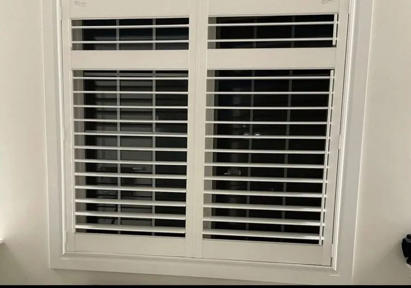Shutters with a split transom on a wide window