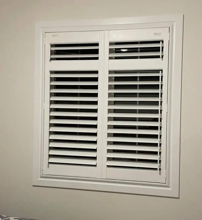 Crisp white shutters set into a window frame