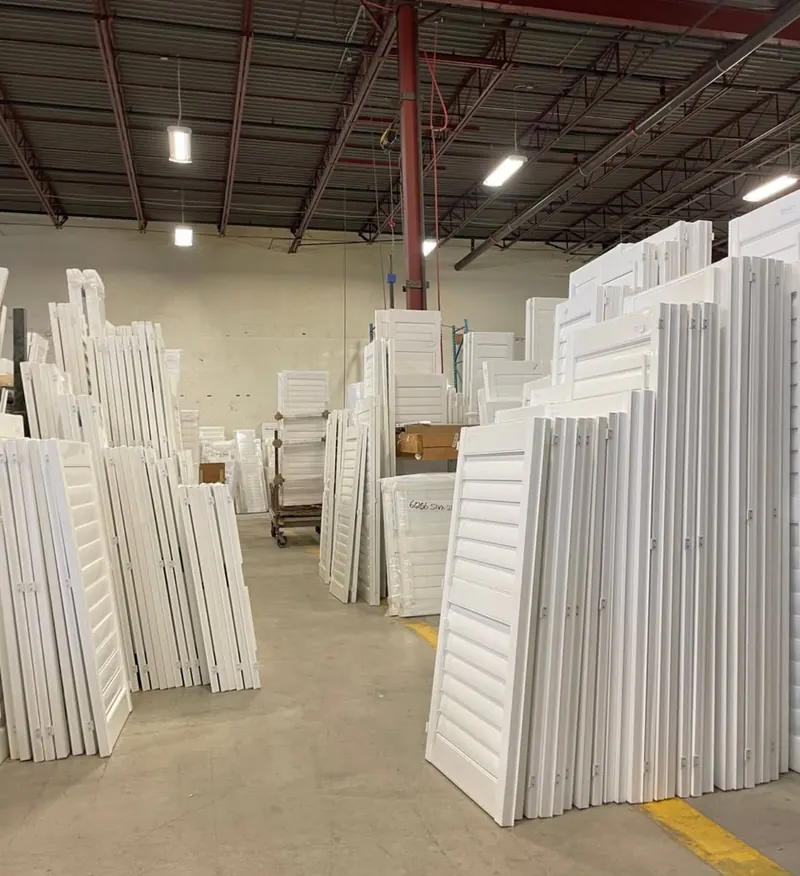 Stacks of finished white shutter panels in the Ontario Blinds workshop in Brampton